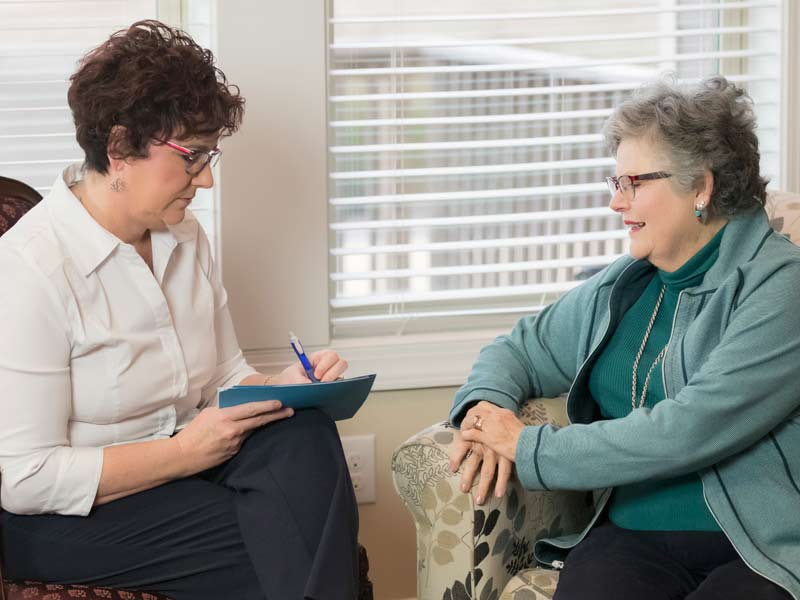 consultant speaking with a couple reviewing papers